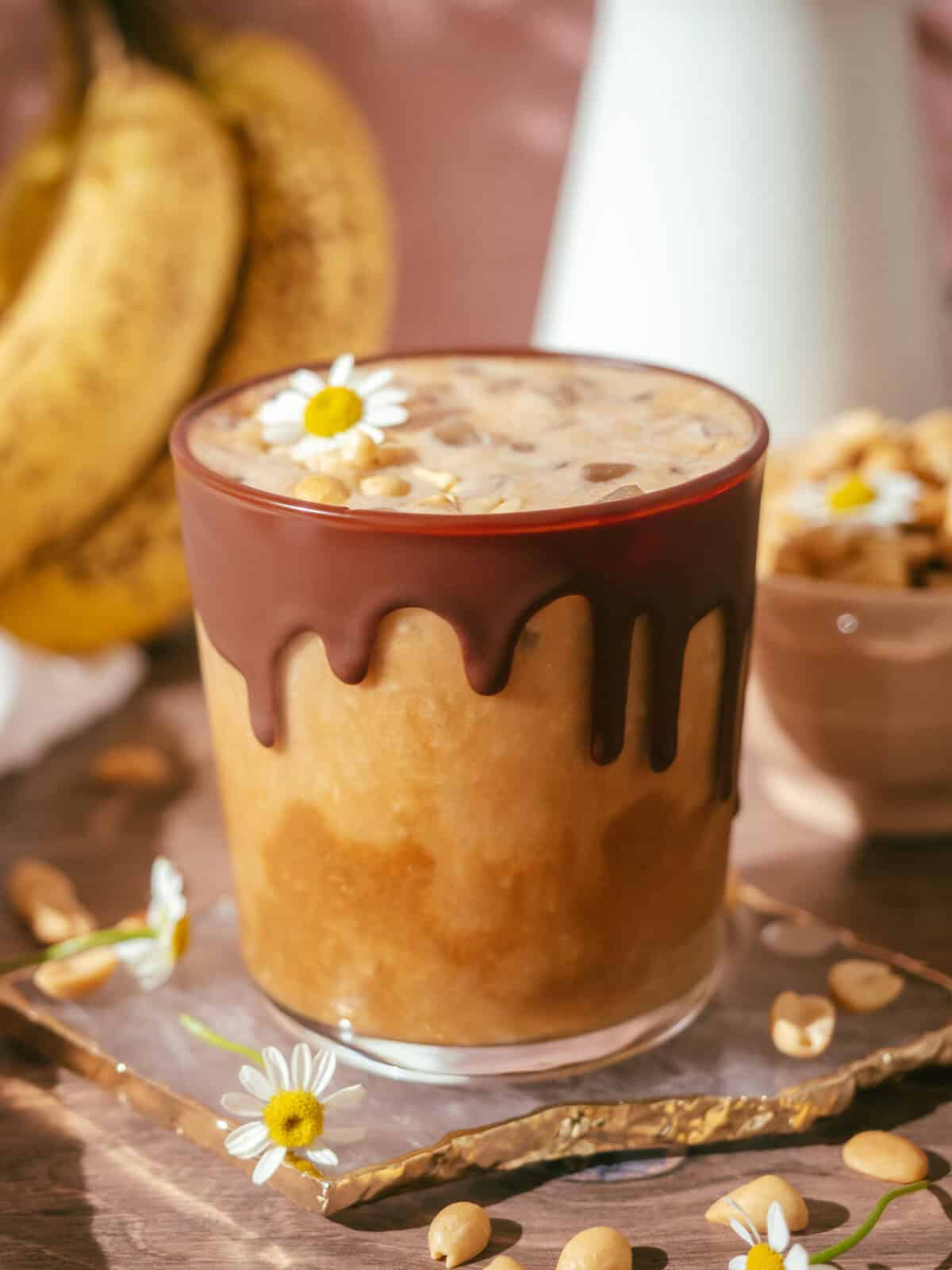 Iced Peanut Butter Banana Latte in a Chocolate Dripping Glass Yoko's